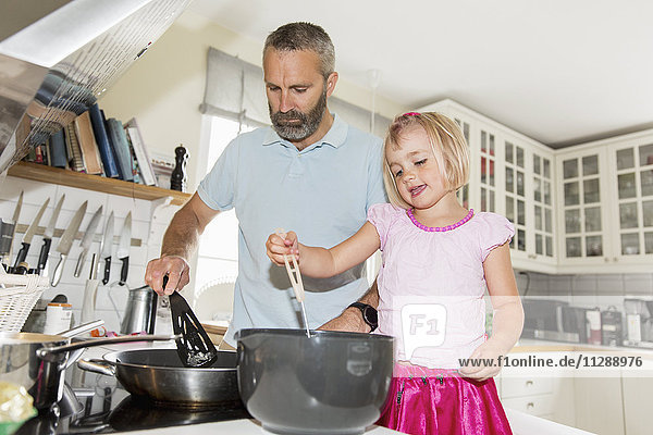 Girl cooking with father
