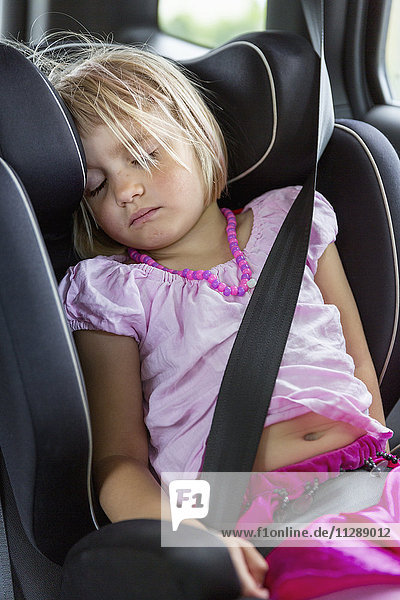 Mädchen schläft im Auto