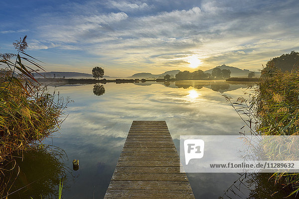 Wooden Jetty with Reflective Sky in Lake at Sunrise  Drei Gleichen  Ilm District  Thuringia  Germany