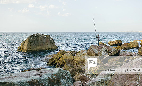 Senior man fishing at the sea