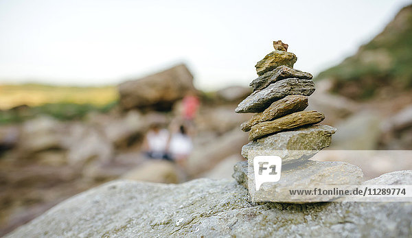 Stack of stone with blurred people in background