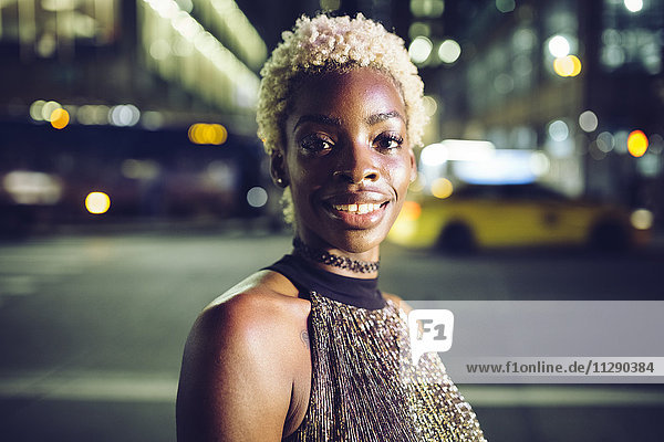 USA  New York City  portrait of happy young woman on Times Square at night