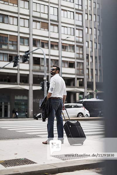 Businessman with suitcase in the city