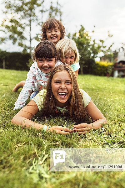 Four girls having fun together on a meadow