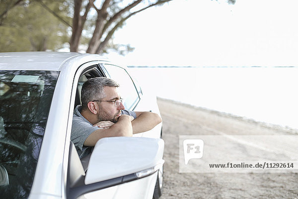 Man sitting in car  taking a break