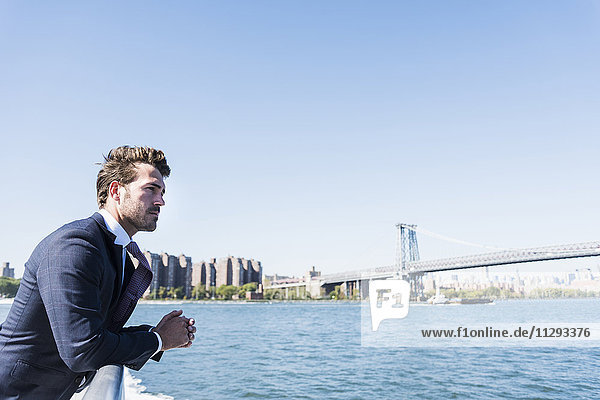 USA  New York City  businessman on ferry on East River