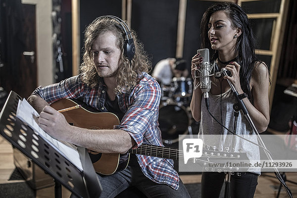 Singer and guitarist in recording studio
