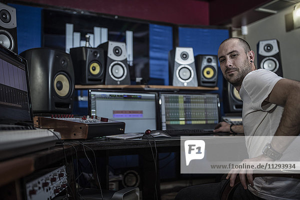 Confident audio engineer in recording studio