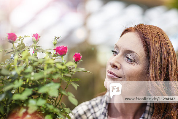 Woman in garden center with potted flowers