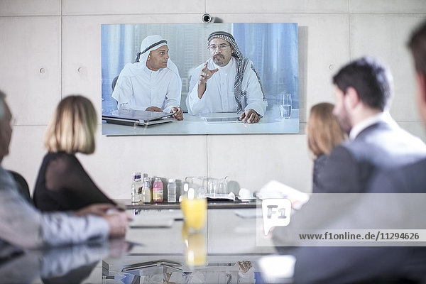 Business people in video conference with clients from the Middle East