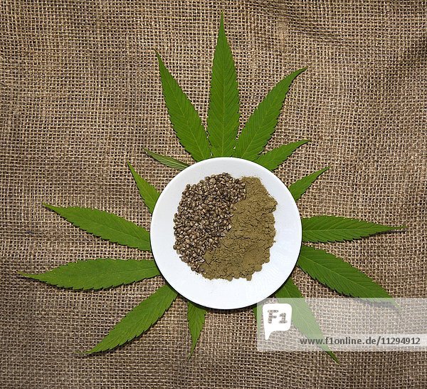 Hemp leaves (Cannabis) with hemp seeds and ground hempseed
