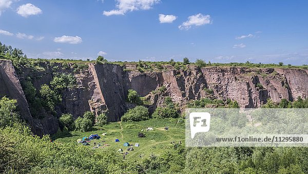 Disused quarry with tents  red porphyry  center for rock climbing  Löbejün  near Halle  river Saale  Saxony-Anhalt  Germany  Europe
