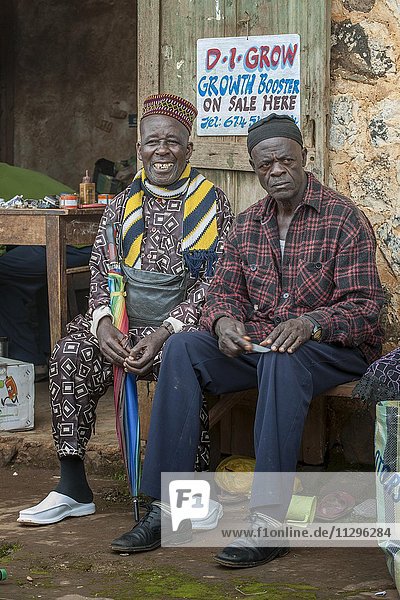 Two men sitting on bench at market  Fundong  Northwest Region  Cameroon  Africa