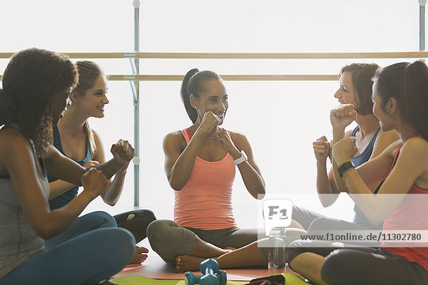 Frauen gestikulieren mit den Fäusten im Fitnessstudio der Gymnastikklasse