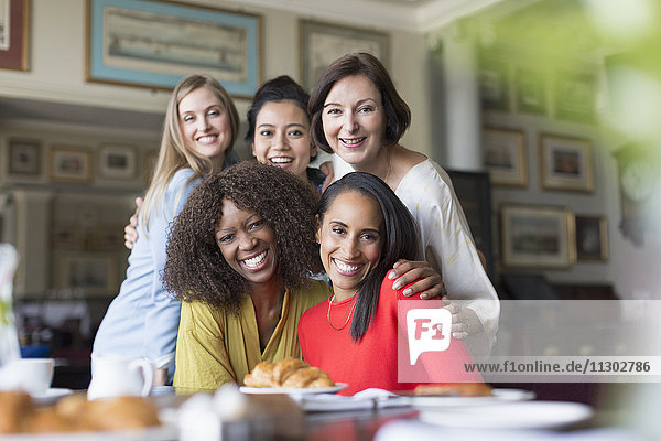 Portrait smiling women friends dining at restaurant table