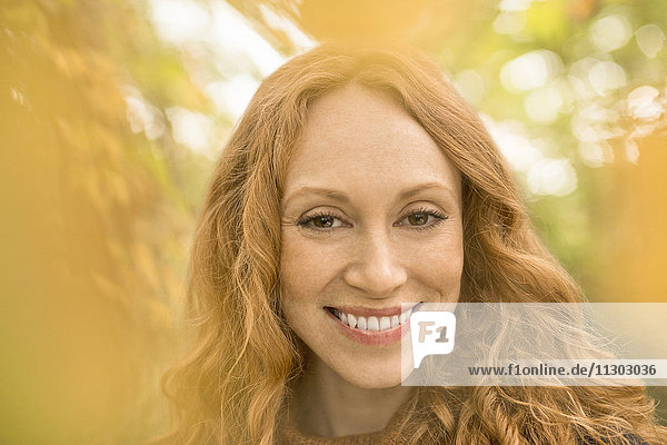 Nahaufnahme Porträt lächelnde Frau mit roten Haaren