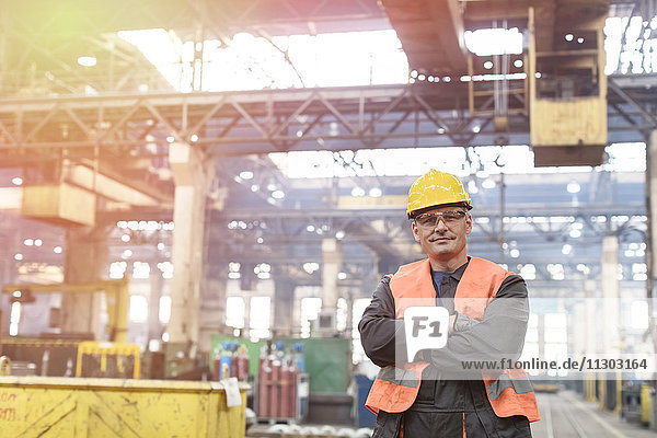 Portrait confident steel worker in factory