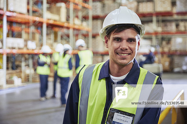 Portrait smiling worker in distribution warehouse