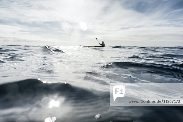 Person kayaking on sea