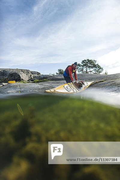 Person with kayak at sea