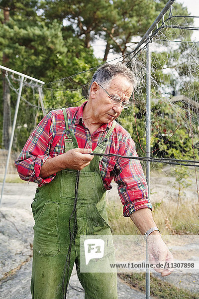 Man repairs fishing net
