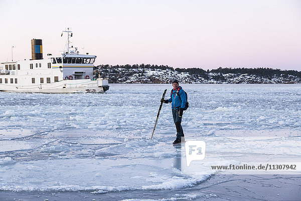 Man near boat on frozen sea