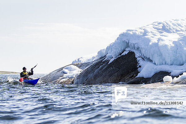 Person kayaking on sea