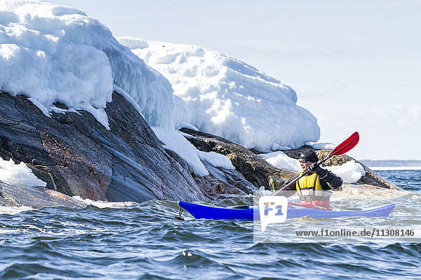 Person kayaking on sea