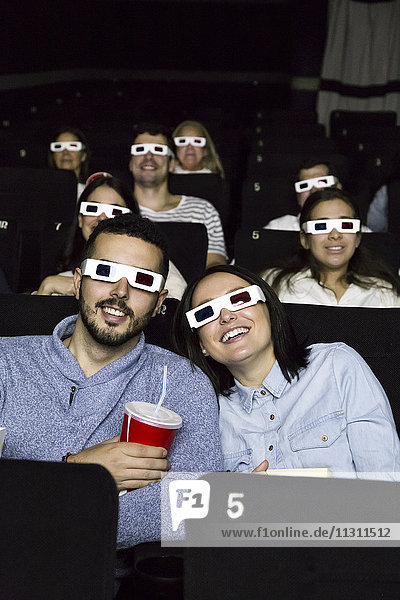Couple with 3d glasses watching a movie in a cinema