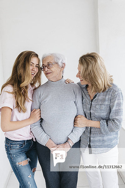 Young woman talking with mother and grandmother