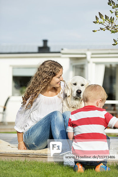 Mother with son and dog in garden