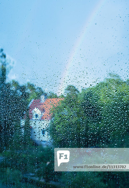 Rainbow seen through wet glass