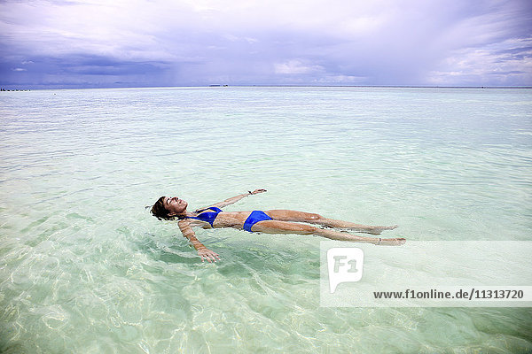 Malediven  Gulhi  Frau im Flachwasser schwimmend