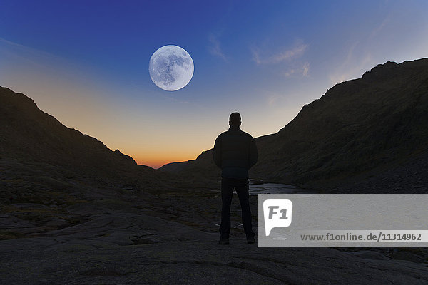 Spain  Sierra de Gredos  silhouette of man looking at the full moon
