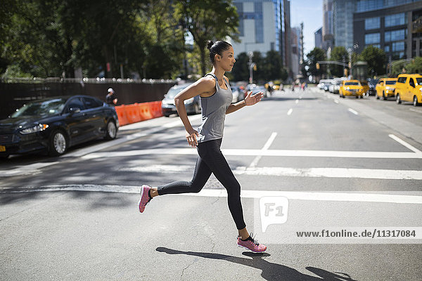 USA  New York City  woman running on urban street