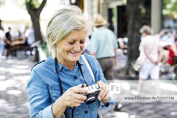 Smiling senior woman with camera