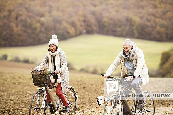 Senior couple doing a bicycle trip with dog
