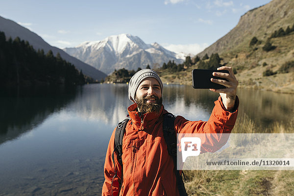 France  Pyrenees  Pic Carlit  hiker taking a selfie at mountain lake