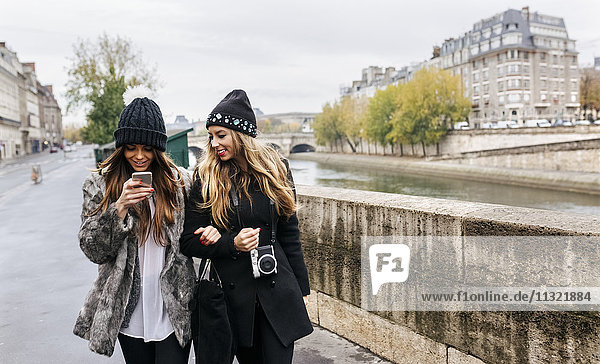 Paris  France  two women strolling near Seine River