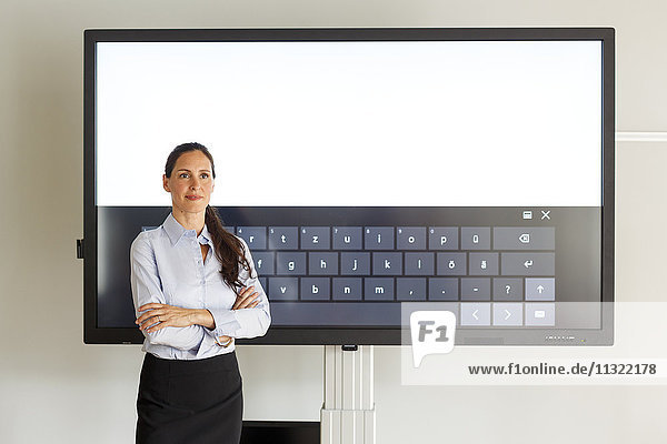 Businesswoman standing of projection of a keyboard