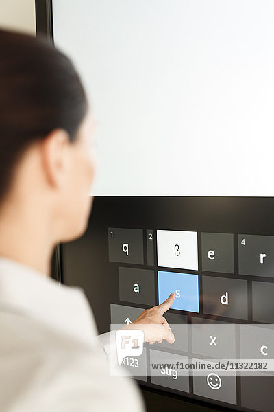 Businesswoman using projection of a keyboard