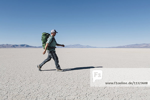 Male backpacker hiking in vast desert  Black Rock Desert  Nevada