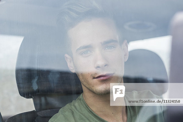 Portrait of young man in a car
