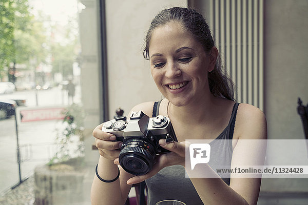 Lächelnde junge Frau in einem Café mit Blick auf die Kamera