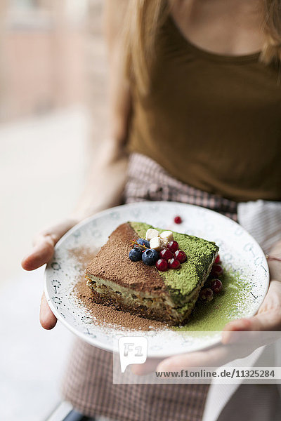 Woman preparing vegan matcha cake