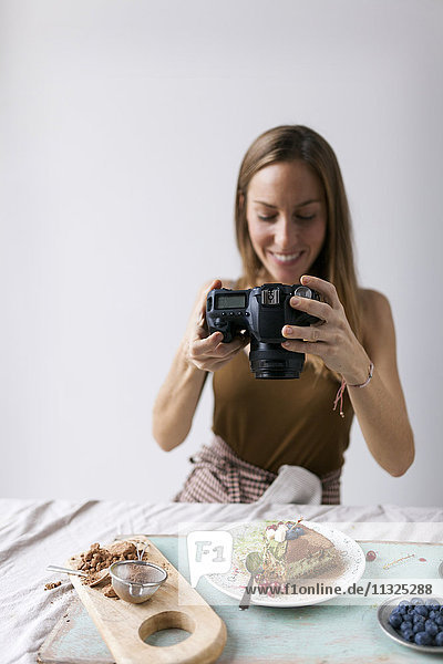 Woman photographing vegan matcha cake