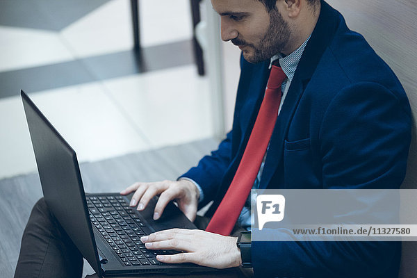 Businessmann using laptop in office