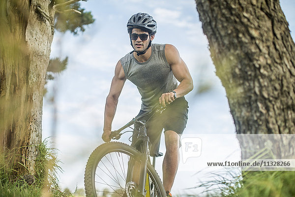 Young man mountain biking in nature