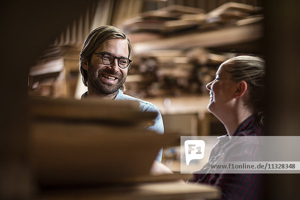Mann und Frau bei der Arbeit in der Holzverarbeitung