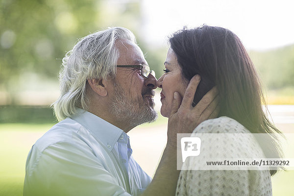 Senior couple kissing outdoors